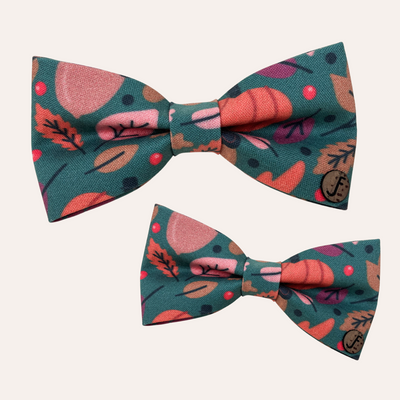 Green bow tie with fall pattern of pumpkins, leaves and acorns