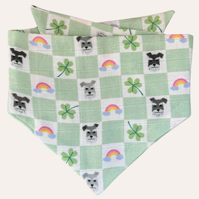 Green and cream check pattern soft dog bandana with pattern of rainbows, clovers and schnauzer faces