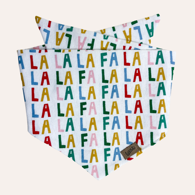 Flannel white bandana with multi colored text reading "Fa la la la"