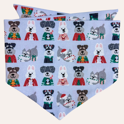 Light blue dog bandana featuring different schnauzers for christmas in sweaters and santa hats