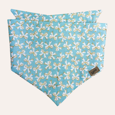 Light robin's egg blue dog bandana with white scattered ribbon bow pattern and metallic gold accents