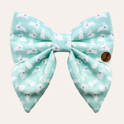 Mint colored sailor bow for dog and cat collars featuring a white bunny print. Each bunny wears a black ribbon collar.