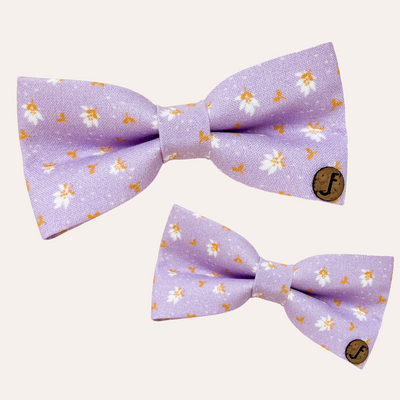 Light purple bow with white flowers and gold leaves