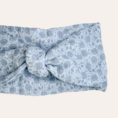 Silver knotted scarf featuring gray floral pattern