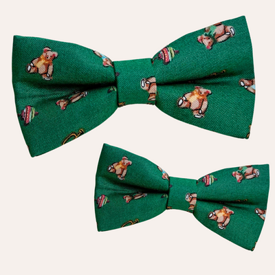 Green bow ties with vintage toy pattern, primarily teddy bears and spinning tops and trumpets