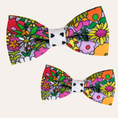 Colorful retro floral bow tie for cats and dogs with contrasting black and cream center heart patterned fabric