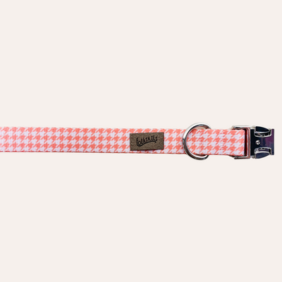 A buckled coral and lilac-gray houndstooth print dog collar with silver metal buckle