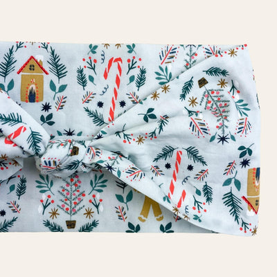 Blue scarf with print of peppermint candy canes and gingerbread cookies and houses