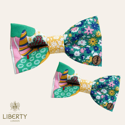 Pet bow ties in mostly green fabric in floral design with yellow, pink, blue, and white flowers.
