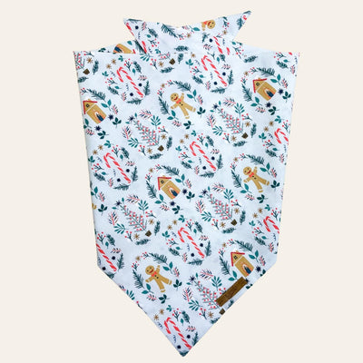 Blue bandana with print of peppermint candy canes and gingerbread cookies and houses