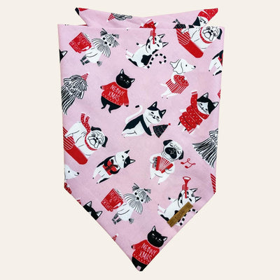 Pink bandana with red, black, white cats and dogs singing and enjoying winter activities