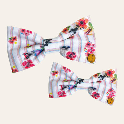 White bow ties with colorful stripes, red flowers, and Archie wearing sunglasses printed on them